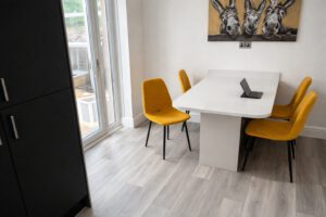 Bright dining space with mustard chairs