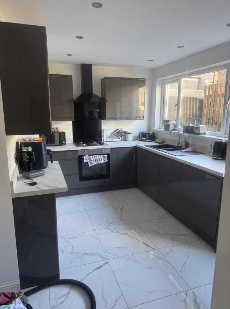 A sleek kitchen with marble floor that we fitted in Swansea