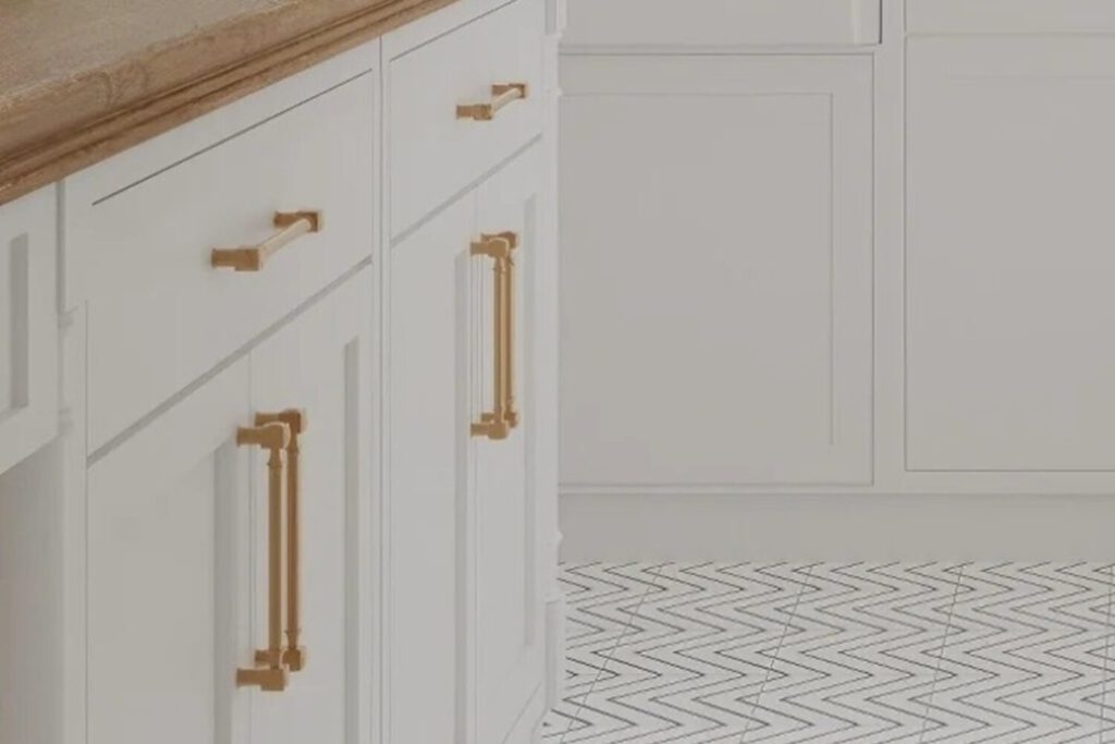 Gold kitchen handle replacements that we fitted on white cabinets
