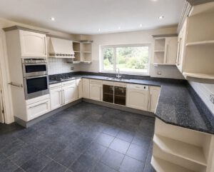 Old U-shaped kitchen with natural light before we knocked the wall through