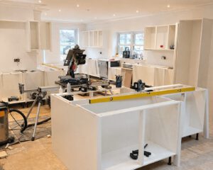 Before photo of the large painted kitchen with island in Penllergaer project